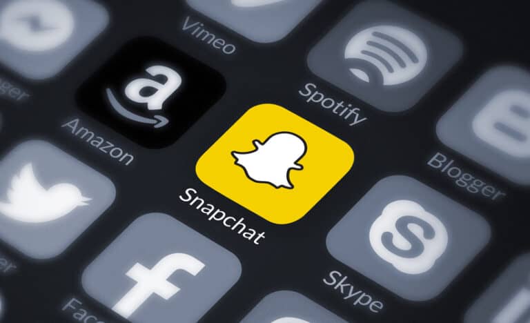 The snapchat logo is shown on a smartphone, representing the Tech Giants in the A.I Crown race.